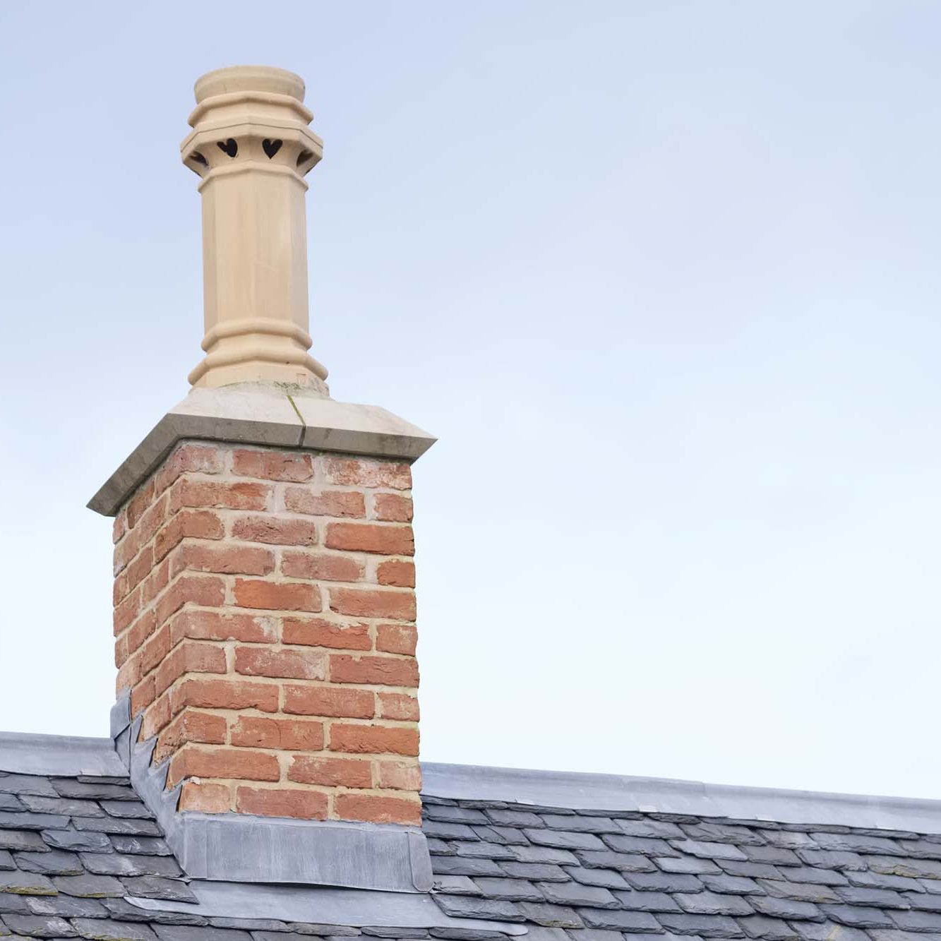 Chimney stack on roof of Victorian style property with blue sky